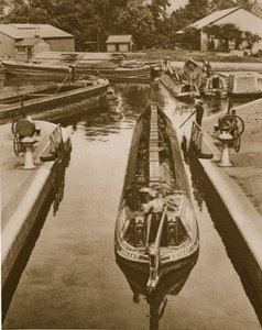 Pushing a monkey boat through a lock at Brentford by English Photographer